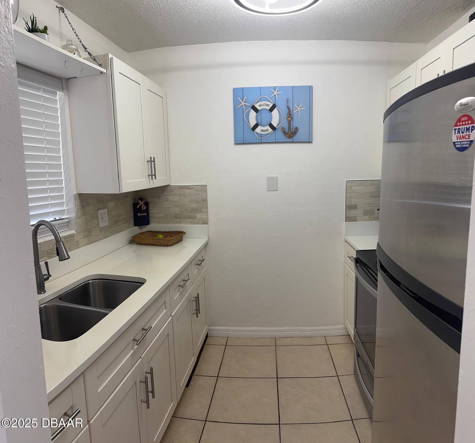 305 Ridge Boulevard, Unit 2110 South Daytona, FL 32119 - Photo 5 of 10 a kitchen with a sink and cabinets
