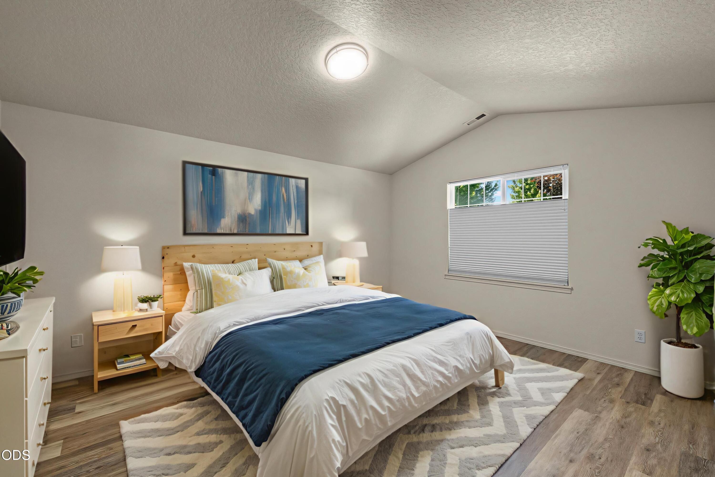 20535 Sunderland Way Bend, OR 97701 - Photo 20 of 41 a bedroom with a bed and a potted plant
