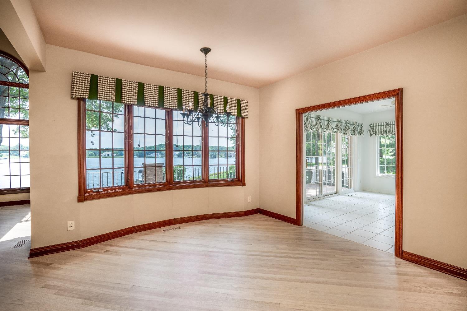 388 Deer Ridge Road Valparaiso, IN 46385 - Photo 11 of 35 a view of an empty room with wooden floor and a window