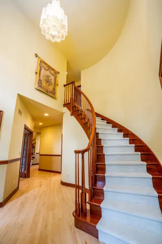 a view of entryway and hall with wooden floor