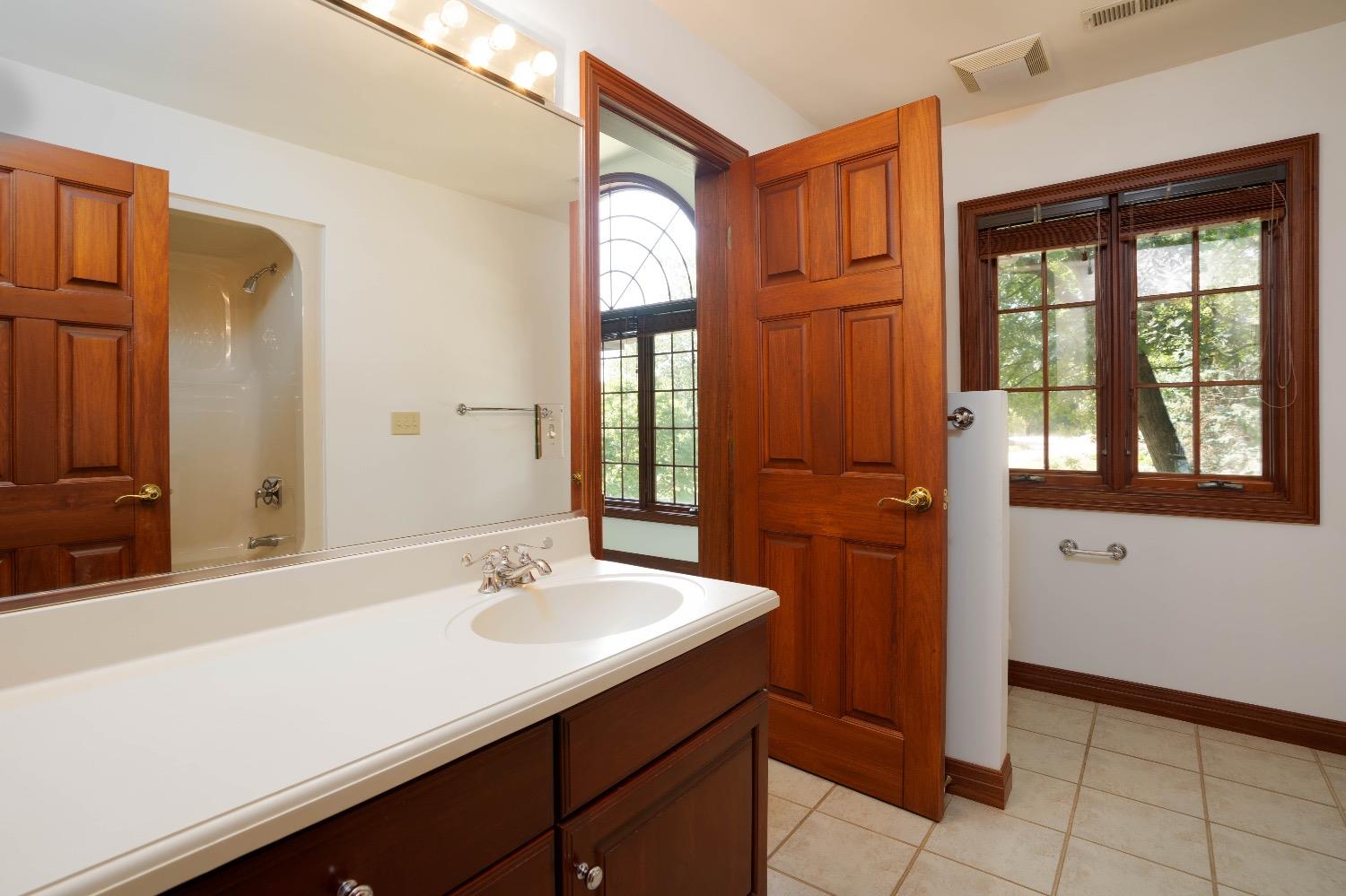 388 Deer Ridge Road Valparaiso, IN 46385 - Photo 18 of 35 a bathroom with a sink a mirror and a window