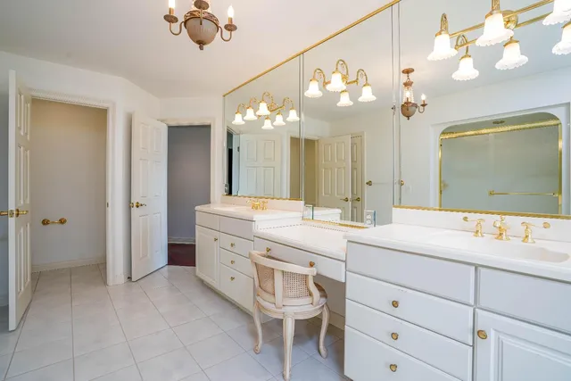 a bathroom with a sink vanity and a mirror