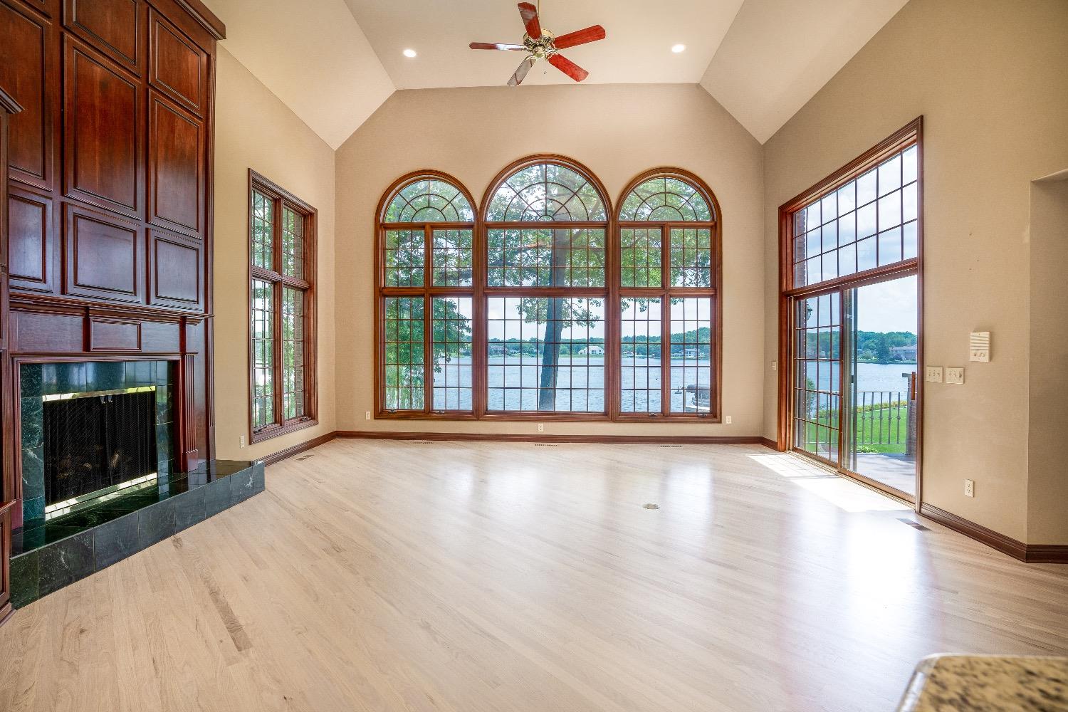 388 Deer Ridge Road Valparaiso, IN 46385 - Photo 7 of 35 a view of an empty room with a fireplace and a window