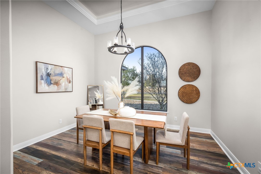 925 River Ranch Circle Martindale, TX 78655 - Photo 25 of 48 a dining room with wooden floor and a table