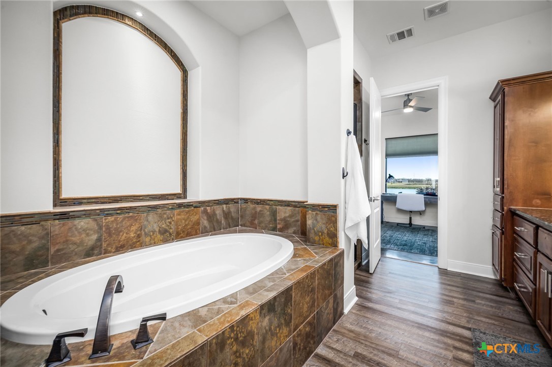 925 River Ranch Circle Martindale, TX 78655 - Photo 29 of 48 a bathroom with a tub and a double vanity sink