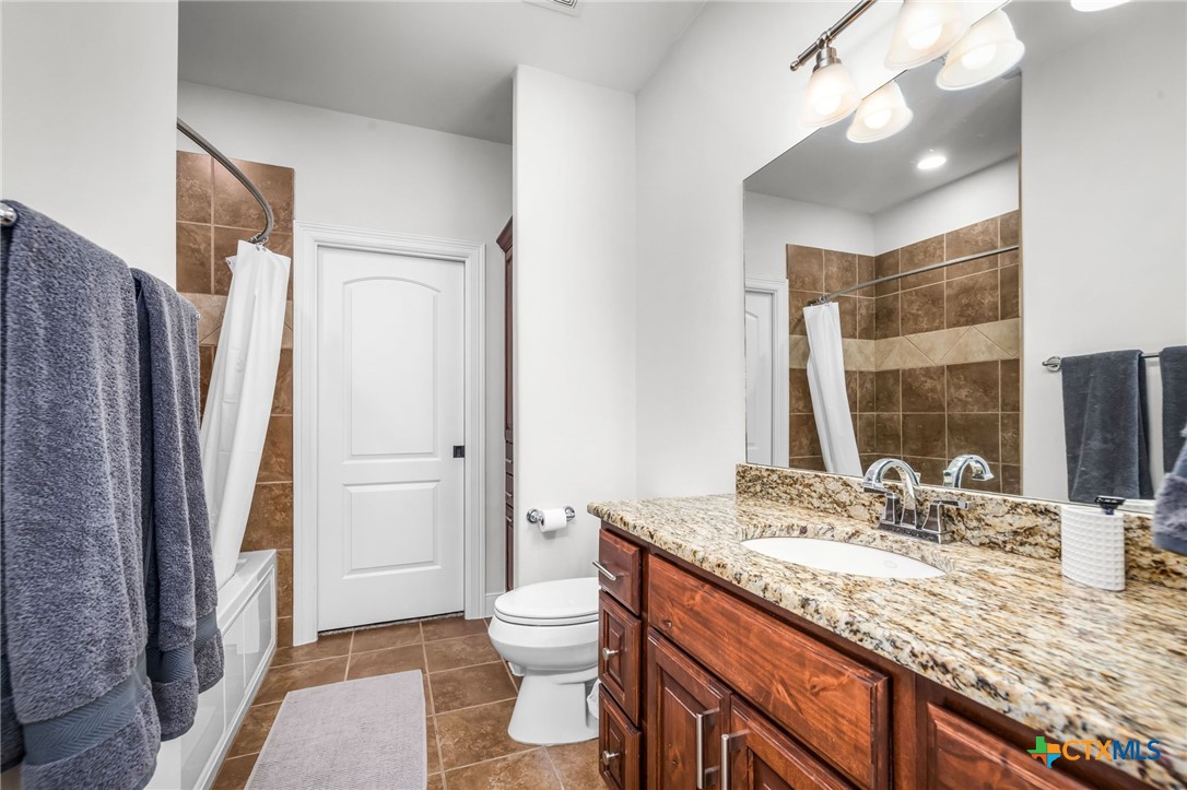 925 River Ranch Circle Martindale, TX 78655 - Photo 34 of 48 a bathroom with a granite countertop sink toilet and shower