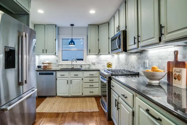 a kitchen with a sink stove and refrigerator
