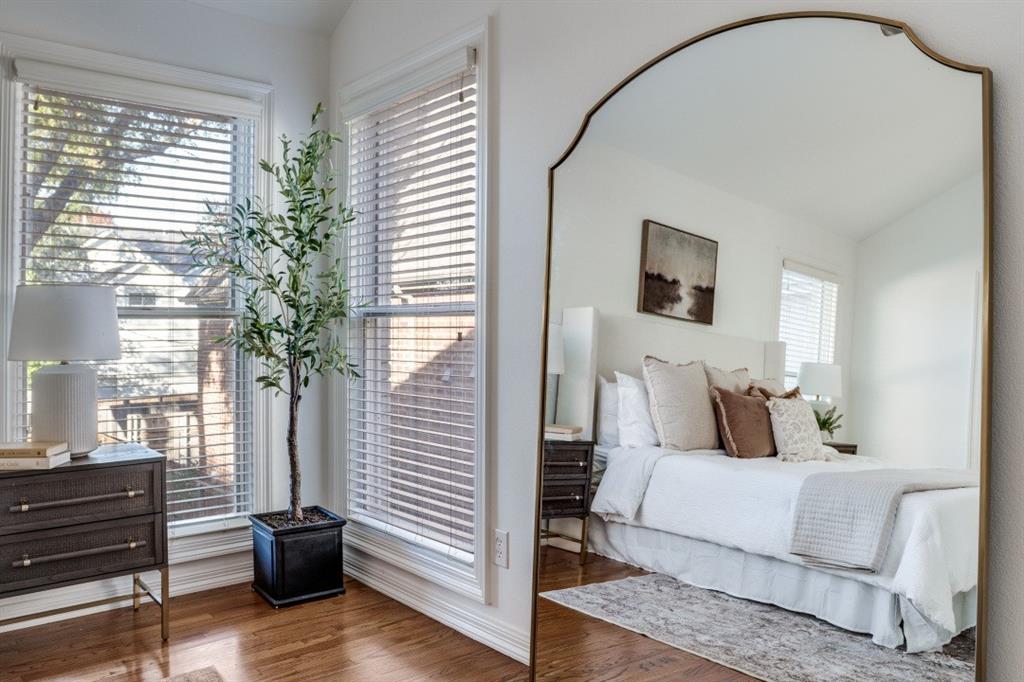 7515 Marquette Street Dallas, TX 75225 - Photo 11 of 25 a bedroom with a bed and a potted plant next to a window