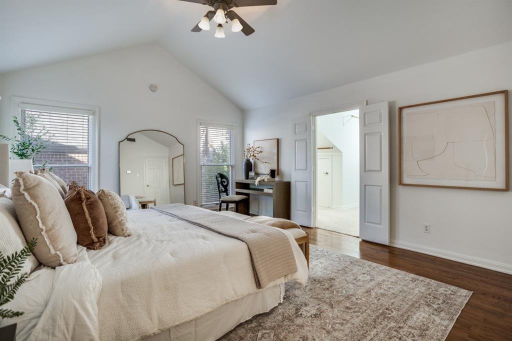 7515 Marquette Street Dallas, TX 75225 - Photo 12 of 25 a bedroom with a large bed and wooden floor