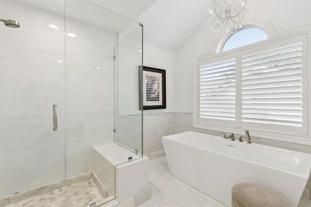 7515 Marquette Street Dallas, TX 75225 - Photo 14 of 25 a bathroom with a tub a sink and a large mirror