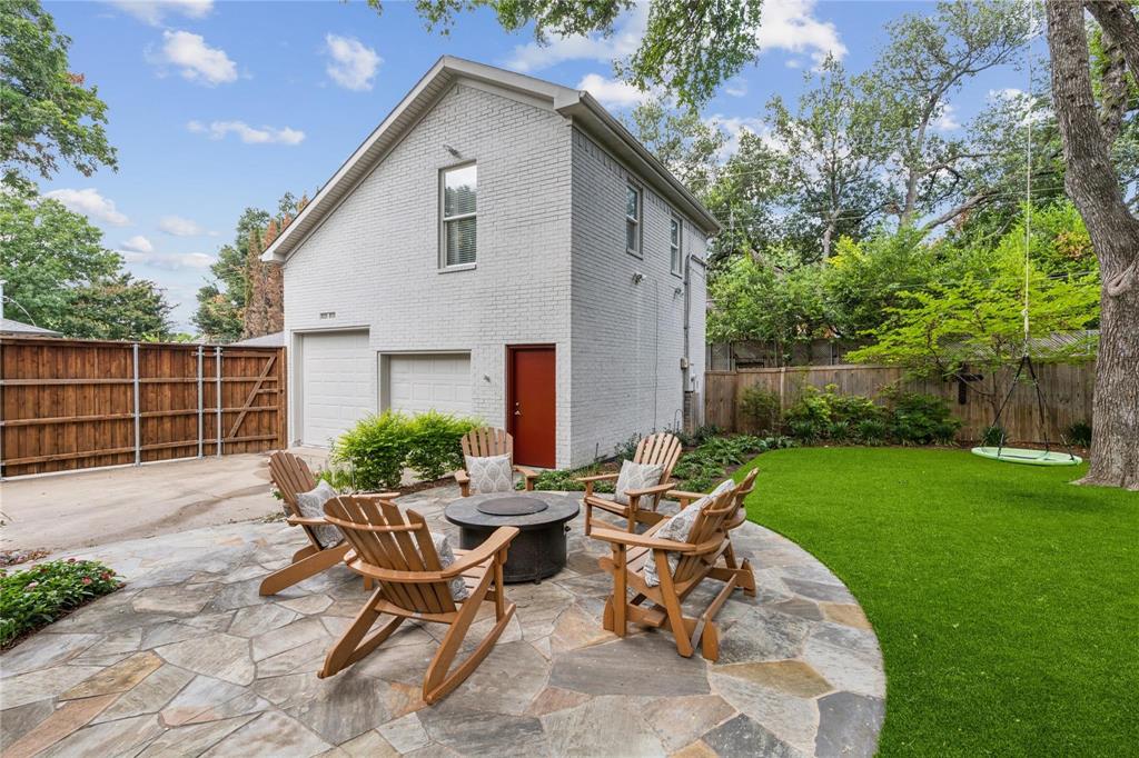 7515 Marquette Street Dallas, TX 75225 - Photo 20 of 25 a view of a patio with table and chairs and potted plants with wooden fence