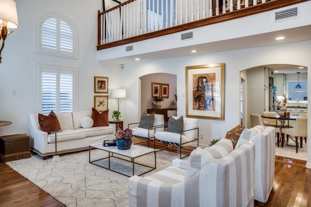 7515 Marquette Street Dallas, TX 75225 - Photo 7 of 25 a living room with furniture a wooden floor and a large window