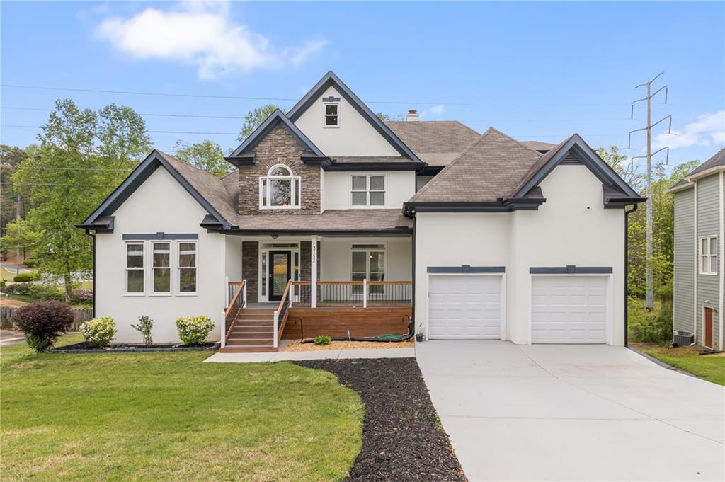 a front view of a house with a yard and garage