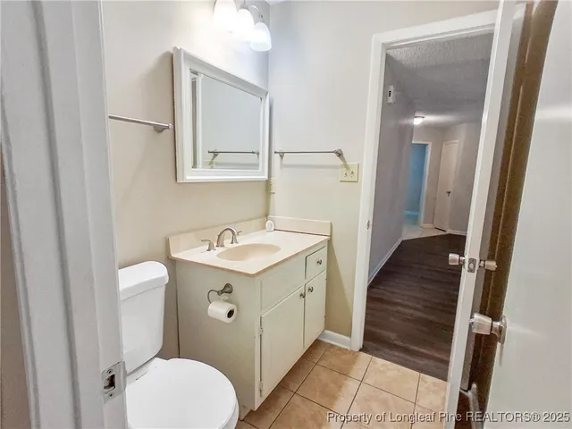 a bathroom with a sink and mirror with toilet