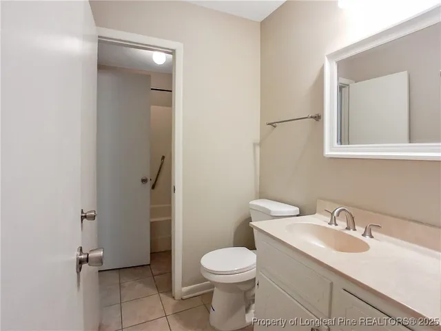 a bathroom with a sink toilet and vanity