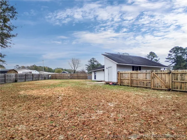 a view of a house with a yard and lake view