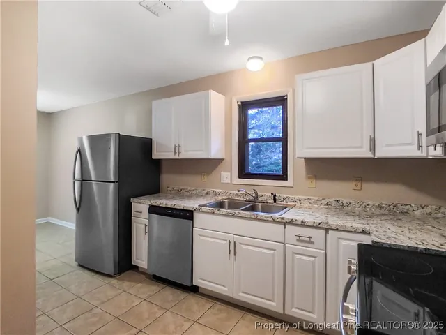 a kitchen with a sink stove and refrigerator
