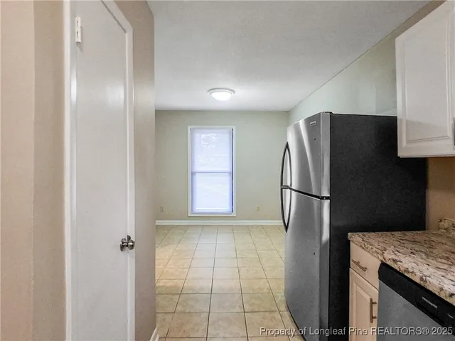 a metallic refrigerator freezer sitting in a kitchen