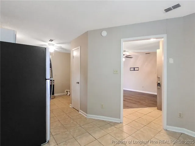 an empty room with closet and a bathroom