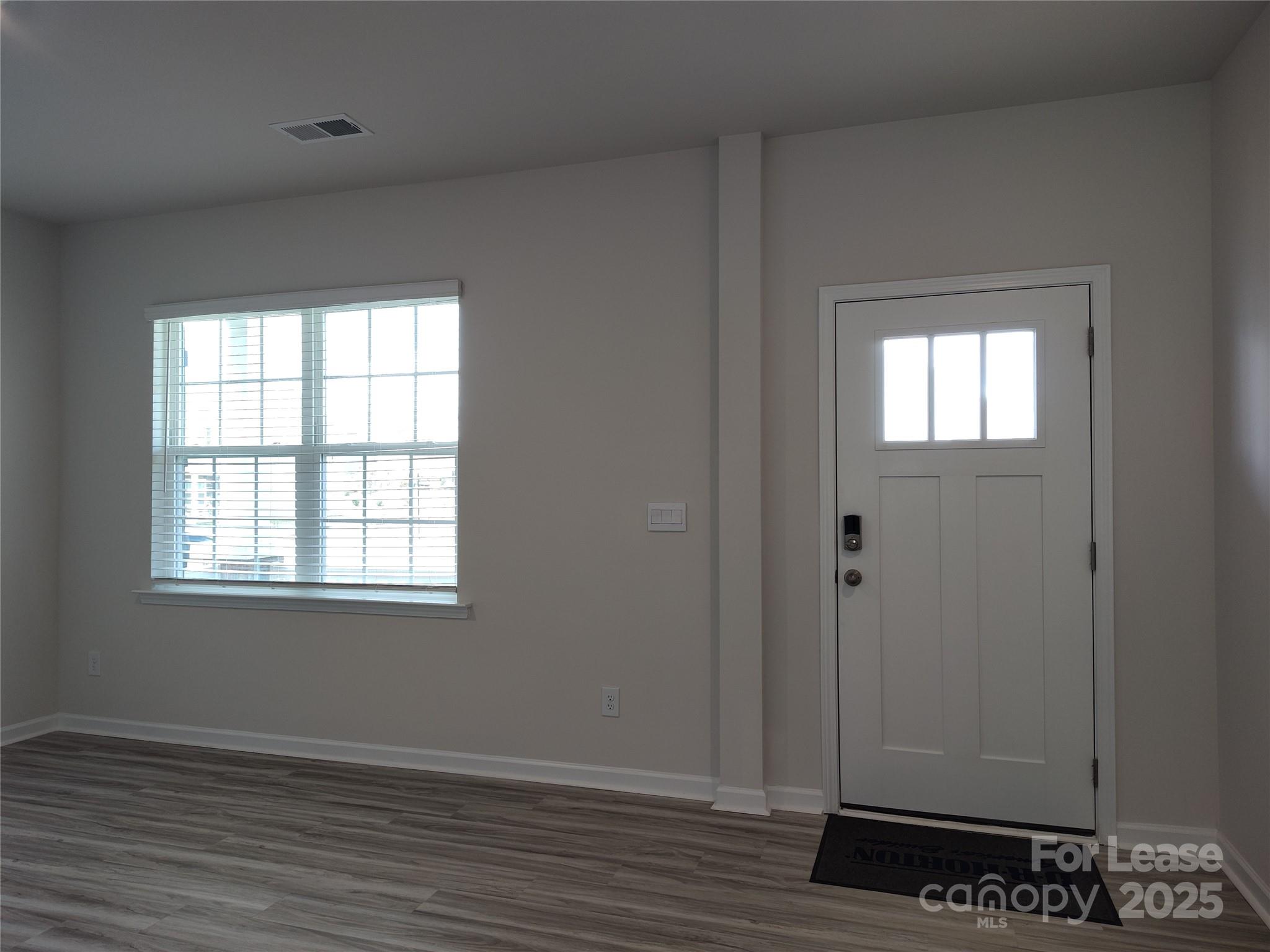 1404 Secrest Cmns Drive Monroe, NC 28112 - Photo 11 of 31 an empty room with wooden floor closet and windows