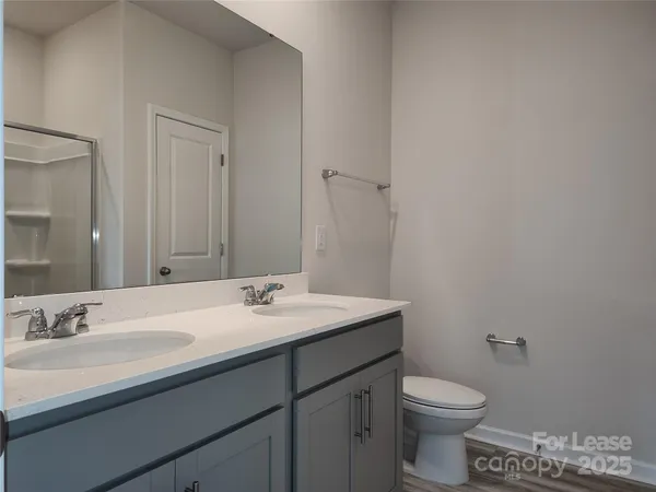 a bathroom with a sink a toilet and mirror