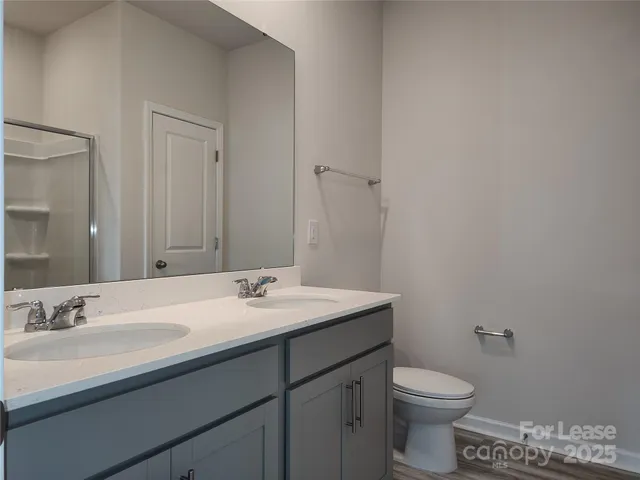 a bathroom with a sink a toilet and mirror