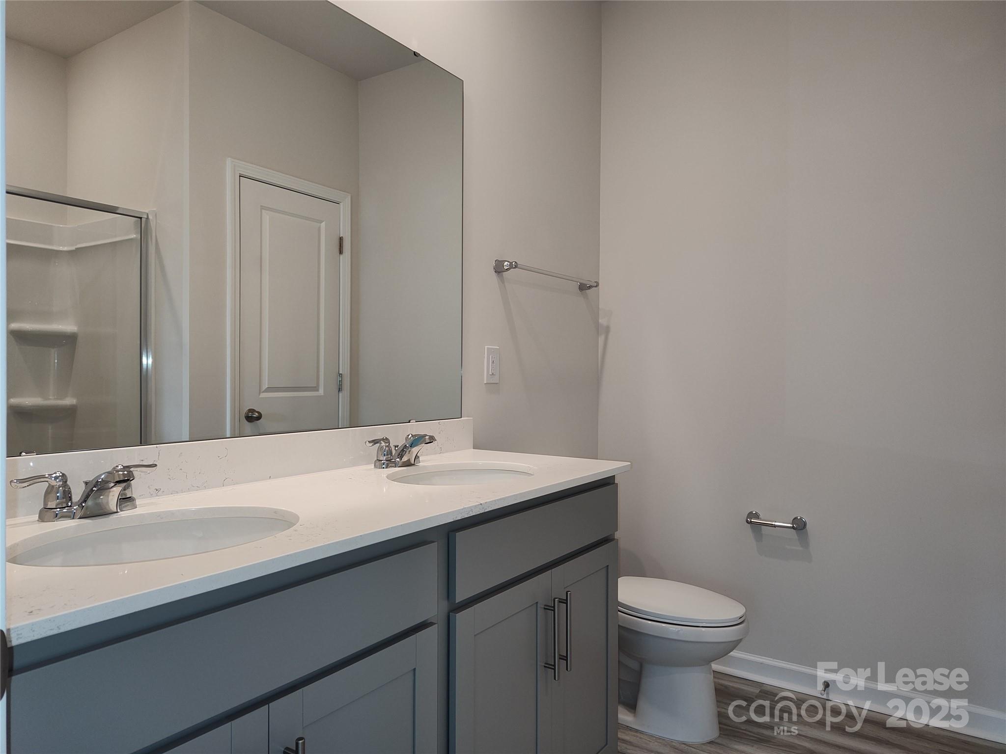 1404 Secrest Cmns Drive Monroe, NC 28112 - Photo 15 of 31 a bathroom with a sink a toilet and mirror