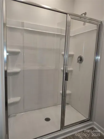 a bathroom with a glass shower door