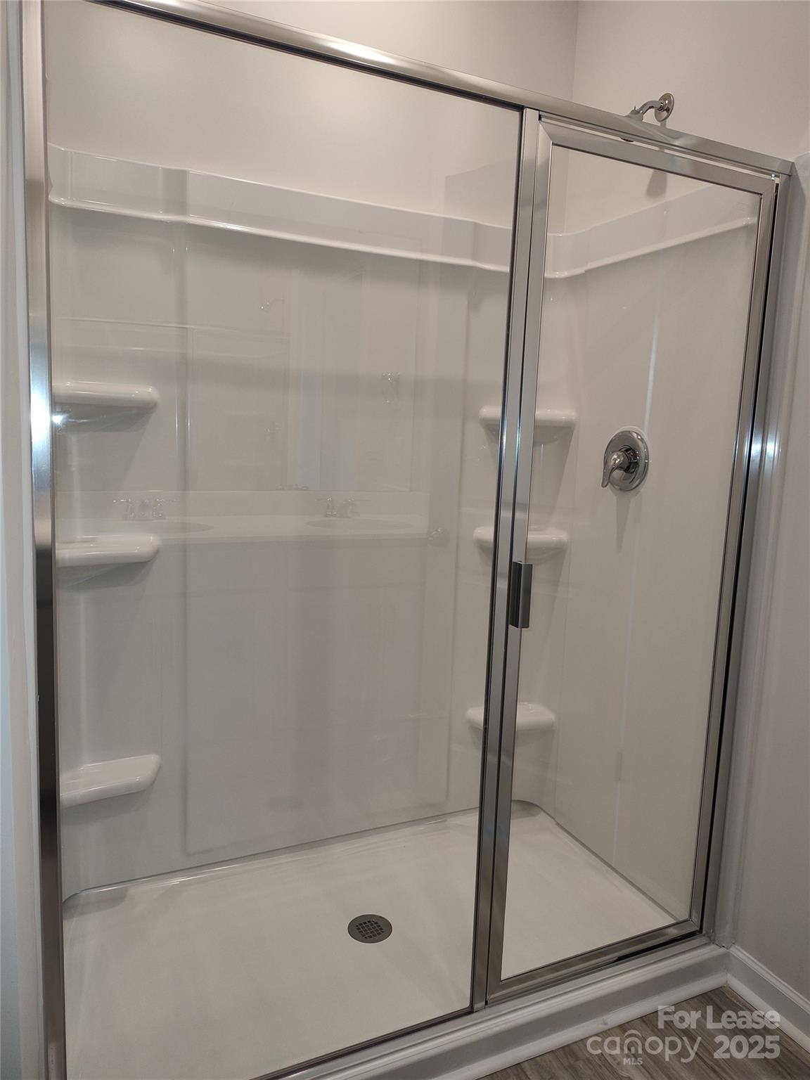 1404 Secrest Cmns Drive Monroe, NC 28112 - Photo 17 of 31 a bathroom with a glass shower door