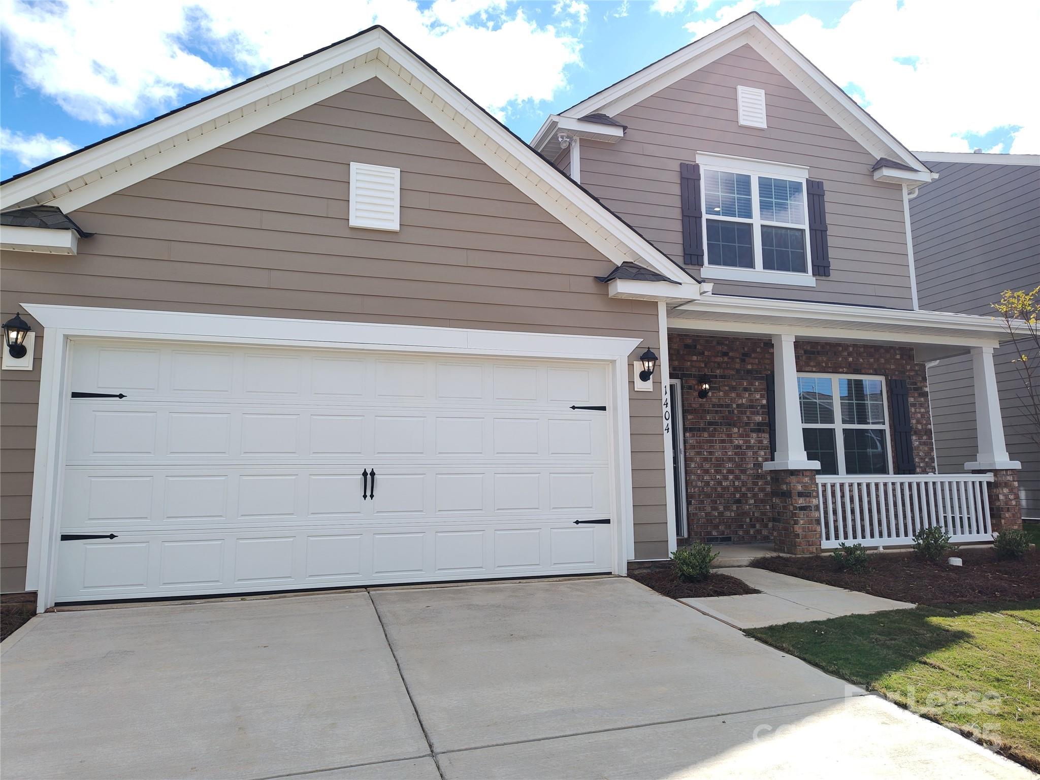 1404 Secrest Cmns Drive Monroe, NC 28112 - Photo 2 of 31 a front view of a house with a yard and garage