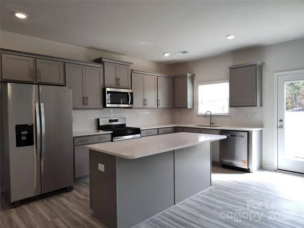 a kitchen with a refrigerator sink and microwave