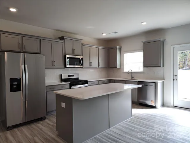 a kitchen with a refrigerator sink and microwave