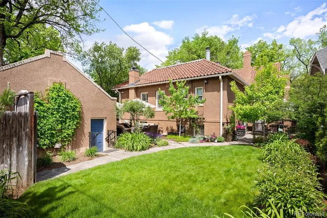 a view of a house with backyard sitting area and garden