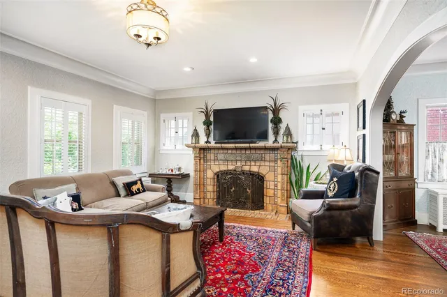 a living room with furniture and a fireplace