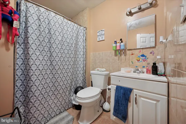 a bathroom with a toilet and a shower curtain