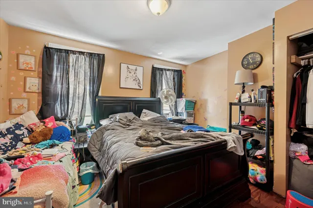 a bed sitting in a bedroom next to a window