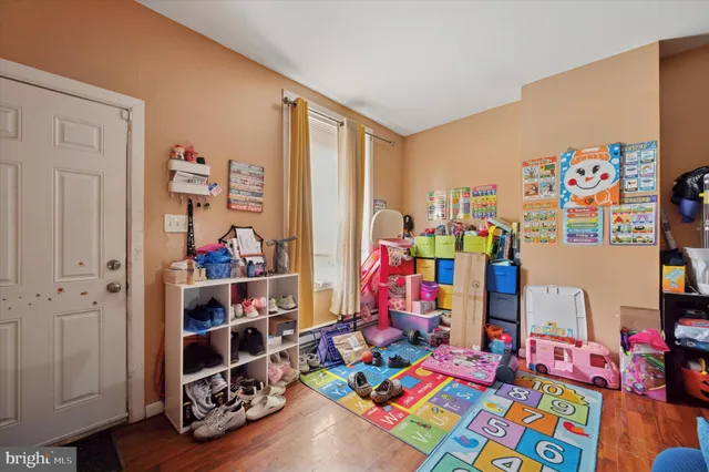 a room with lots of baby toys and wooden floor