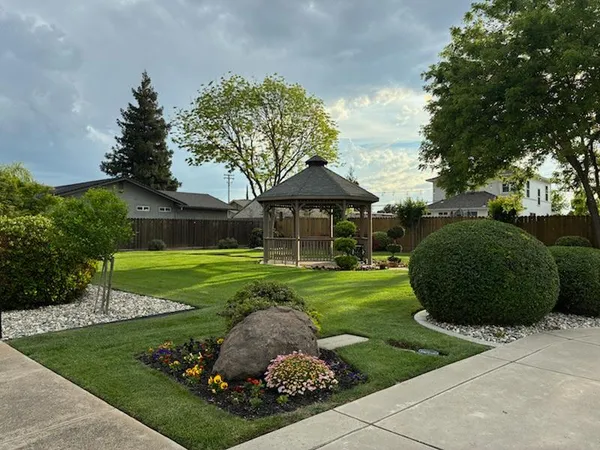 a swimming pool with outdoor seating and yard
