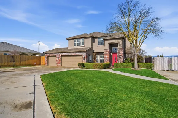 a front view of a house with a yard and garage