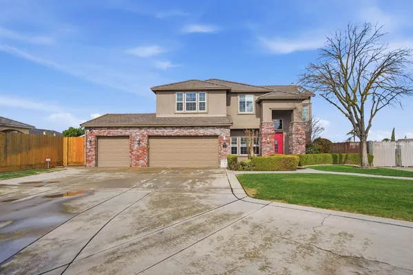 a kitchen with stainless steel appliances kitchen island granite countertop a sink a stove and a refrigerator
