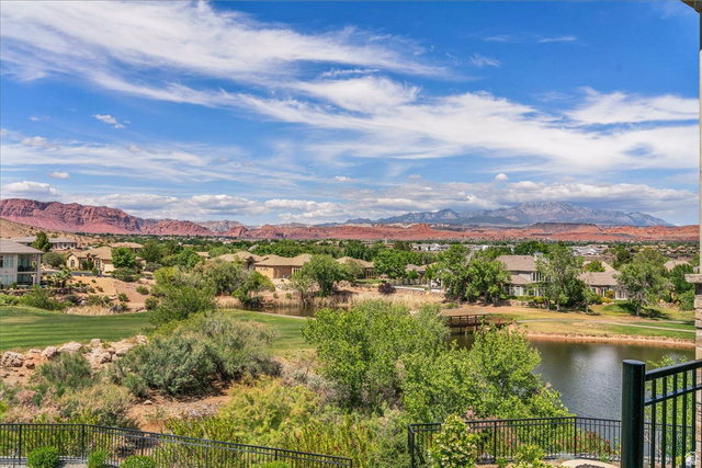 2608 Canyon Ridge Drive St. George, UT 84770 - Photo 52 of 86 Expansive outdoor scenery featuring a serene lake, a manicured golf course, and distant red rock formations