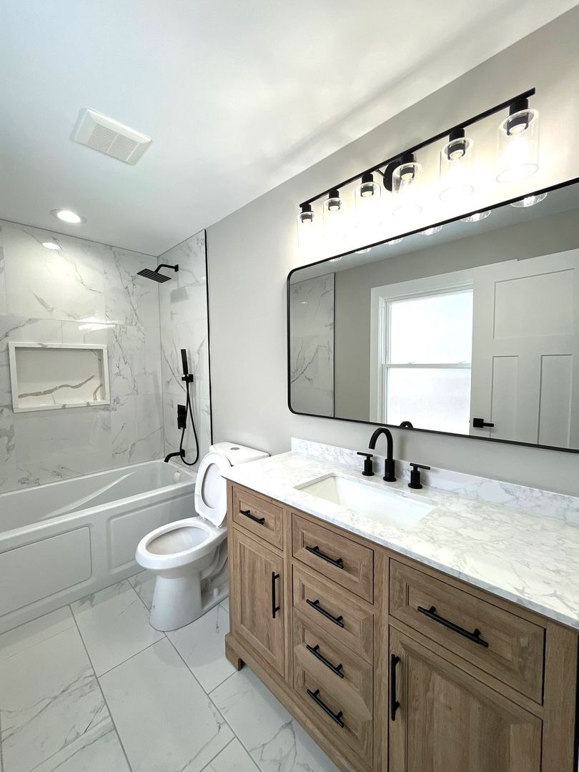 17855 Walter Street Lansing, IL 60438 - Photo 7 of 16 a bathroom with a granite countertop sink mirror vanity bathtub and a toilet