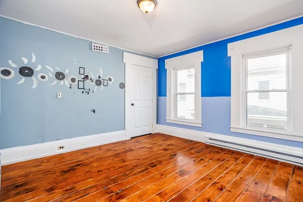 a view of empty room with window and ceiling fan