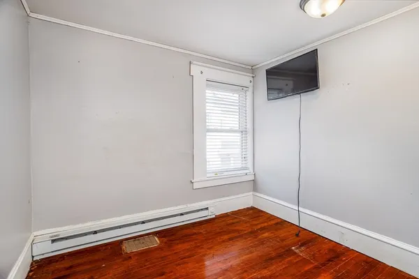 a view of room with window and wooden floor