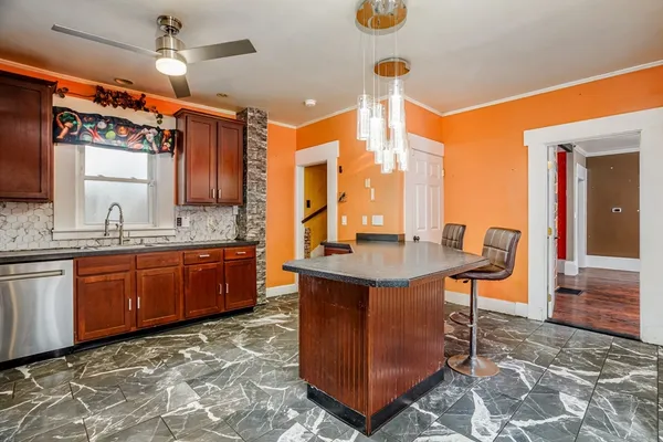 a kitchen with stainless steel appliances granite countertop a sink and a refrigerator