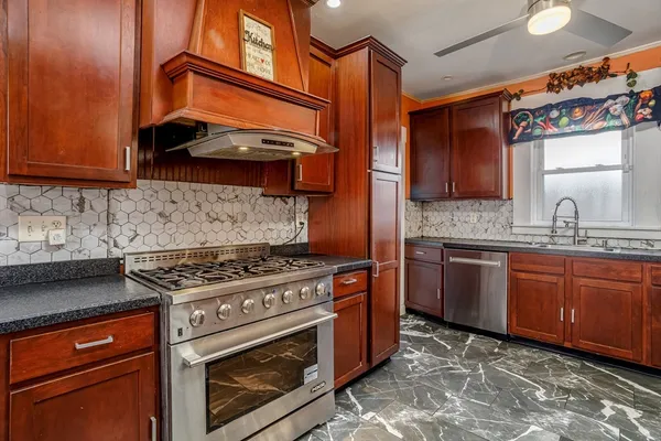 a kitchen with stainless steel appliances granite countertop a stove and a sink