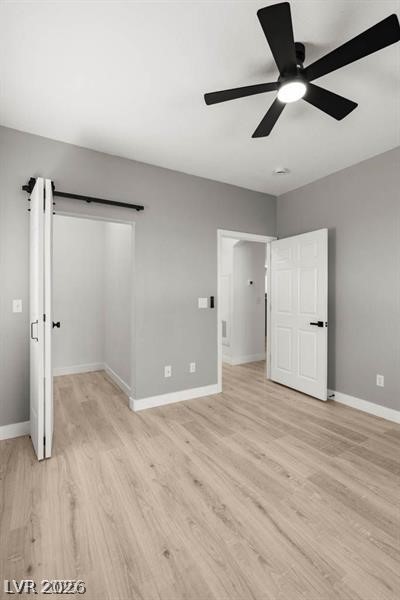3320 South Fort Apache Road, Unit 125 Las Vegas, NV 89117 - Photo 17 of 26 This naturally illuminated bedroom offers versatile space with durable wood flooring and modern barn door access.