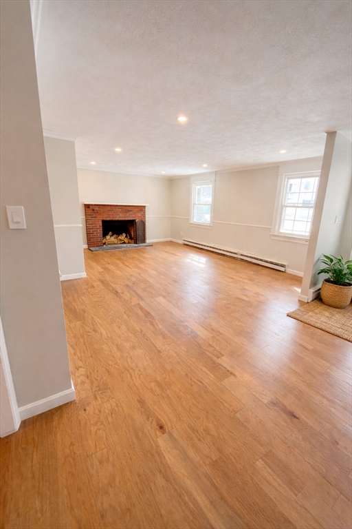 369 Berlin Road Marlborough, MA 01752 - Photo 2 of 12 a view of an empty room with a window and wooden floor