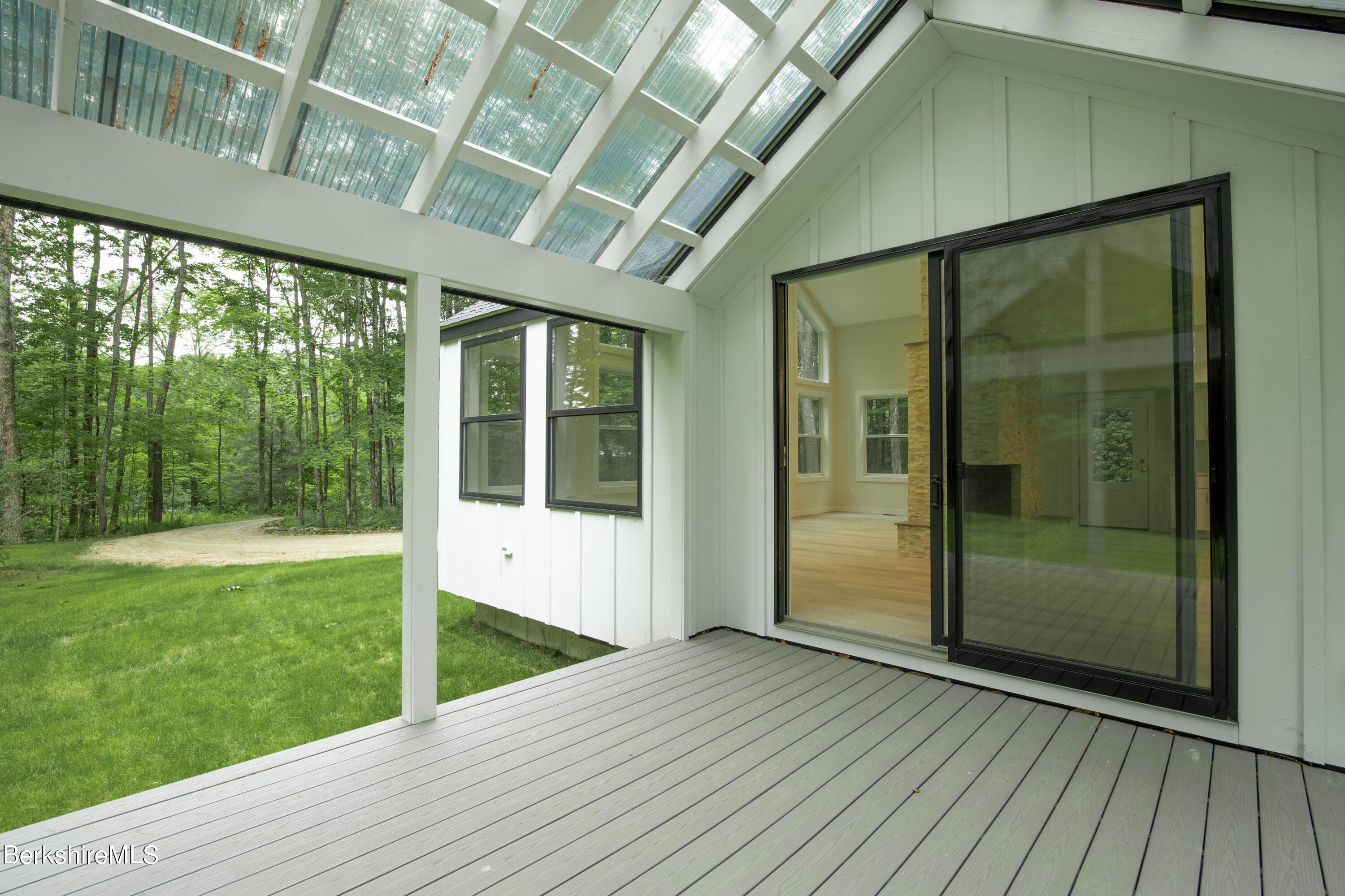 220 Hupi Road Monterey, MA 01245 - Photo 12 of 38 a view of an empty room with wooden floor and outdoor view