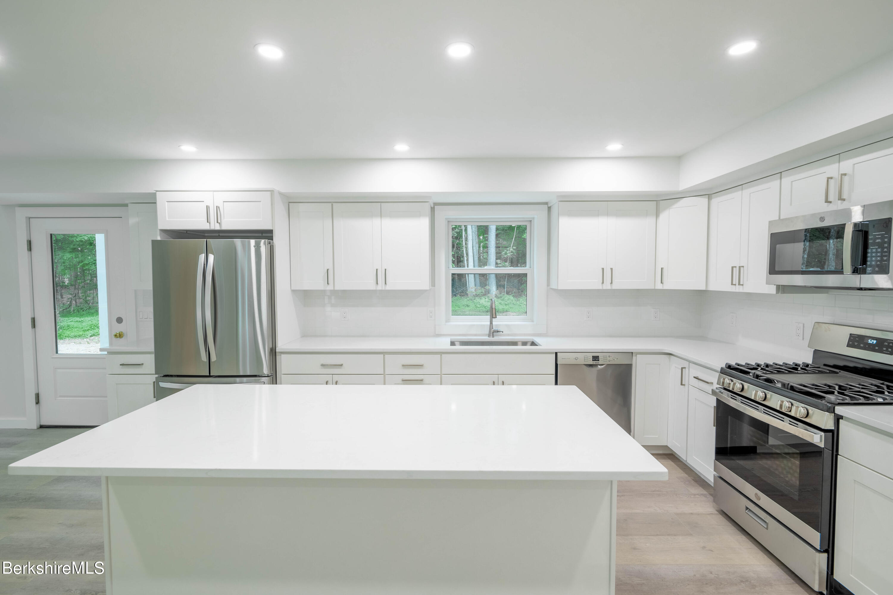 220 Hupi Road Monterey, MA 01245 - Photo 15 of 38 a kitchen with stainless steel appliances granite countertop a sink stove and refrigerator